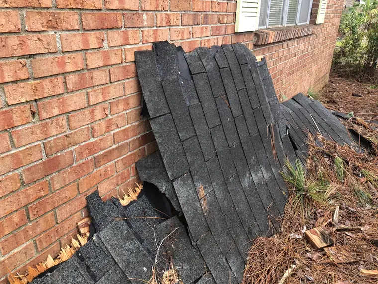 Whole shingle sections torn off by the wind