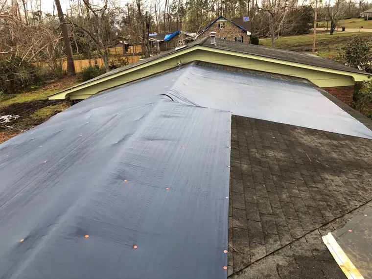 Tarp secured over the damaged section until permanent repair